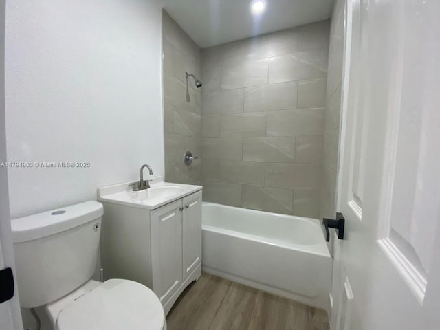 22011 Catherine Prt, Charlotte, FL 33952 - full bathroom featuring toilet, wood finished floors, vanity, and bathtub / shower combination