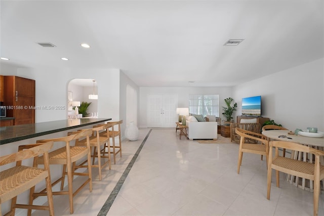 8700 SW 64th Ave, Pinecrest, FL 33156 - living area with arched walkways, recessed lighting, and inlaid floor details