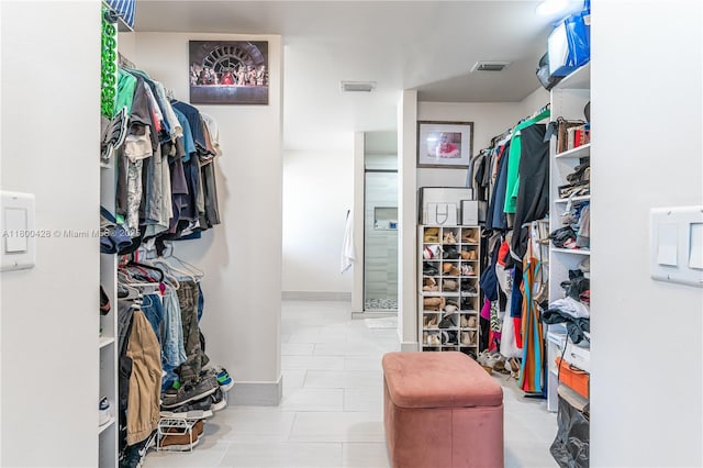 spacious closet with tile patterned floors