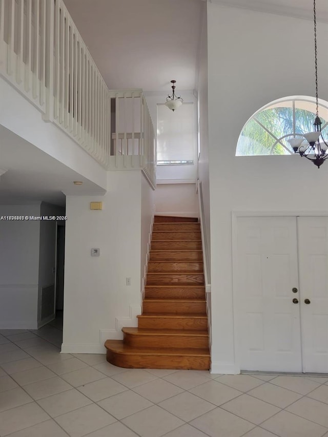 8021 Stirrup Cay Ct, Boynton Beach, FL 33436 - foyer featuring light tile patterned floors, stairway, a high ceiling, and baseboards