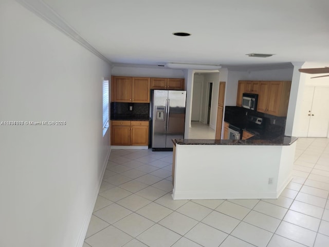 8021 Stirrup Cay Ct, Boynton Beach, FL 33436 - kitchen featuring appliances with stainless steel finishes, backsplash, light tile patterned floors, brown cabinets, and ornamental molding