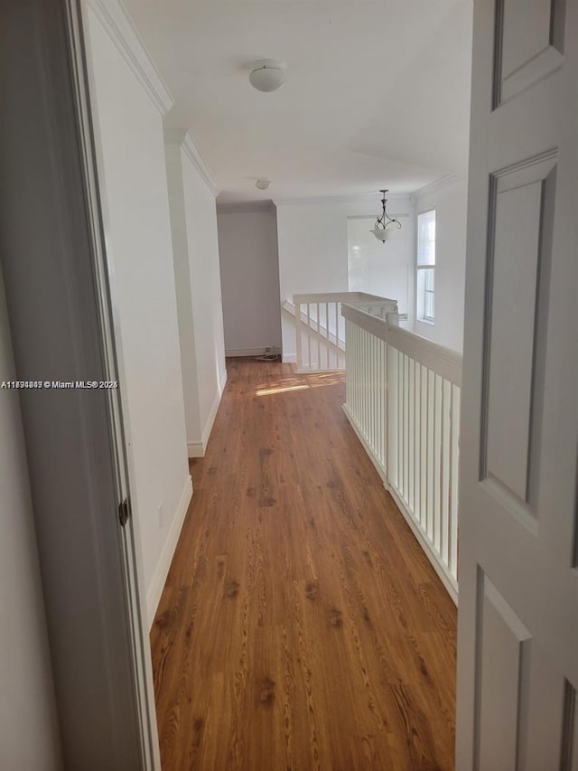 8021 Stirrup Cay Ct, Boynton Beach, FL 33436 - hallway featuring crown molding, wood finished floors, a chandelier, and baseboards