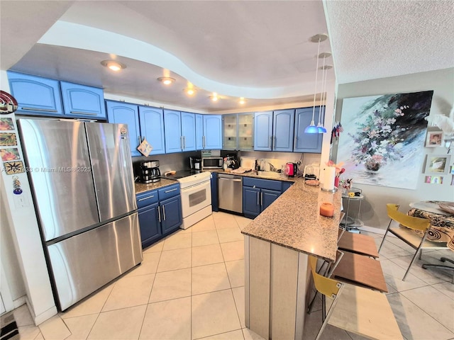 3800 S Ocean Dr Unit 818, Hollywood, FL 33019 - kitchen with stainless steel appliances, blue cabinets, a peninsula, and light tile patterned floors