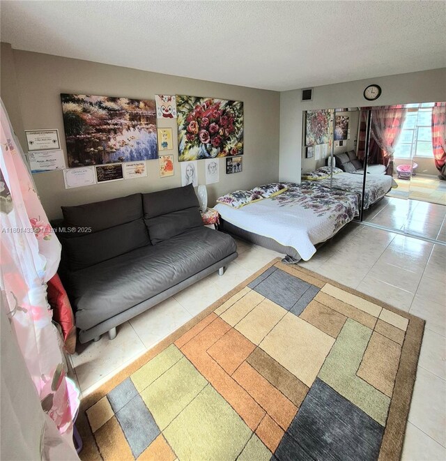 3800 S Ocean Dr Unit 818, Hollywood, FL 33019 - tiled bedroom featuring a textured ceiling