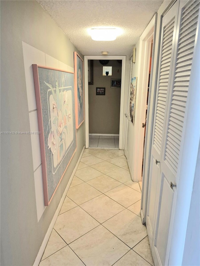 3800 S Ocean Dr Unit 818, Hollywood, FL 33019 - corridor featuring a textured ceiling and light tile patterned flooring