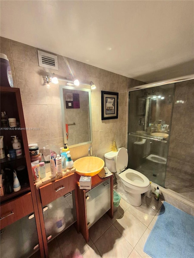 3800 S Ocean Dr Unit 818, Hollywood, FL 33019 - full bathroom featuring tile walls, tile patterned flooring, toilet, a shower stall, and vanity