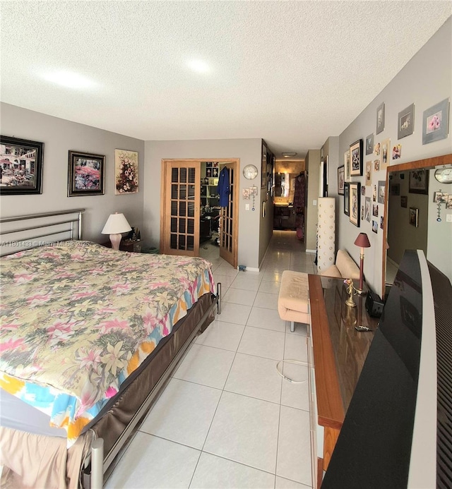 3800 S Ocean Dr Unit 818, Hollywood, FL 33019 - bedroom with light tile patterned flooring, french doors, and a textured ceiling