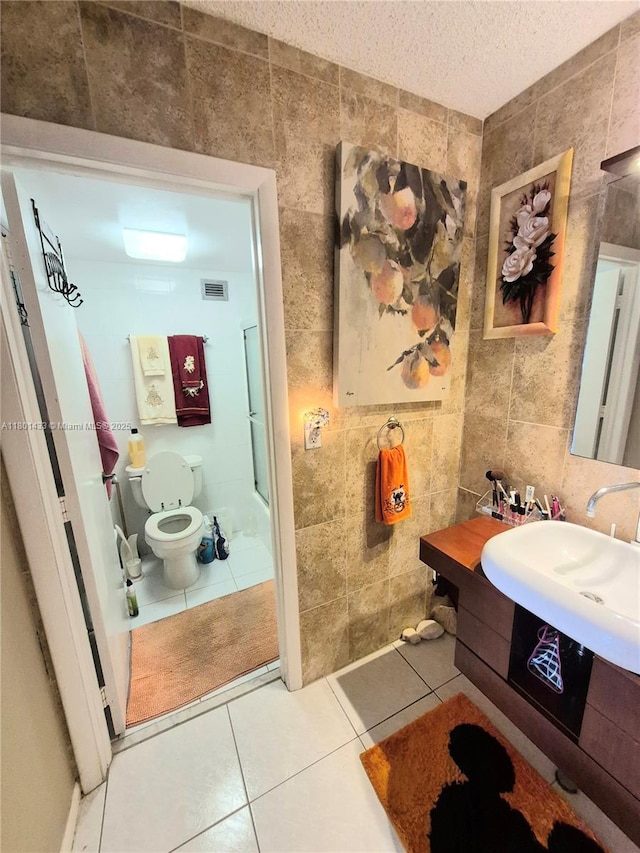 3800 S Ocean Dr Unit 818, Hollywood, FL 33019 - bathroom with tile walls, tile patterned floors, a sink, toilet, and a textured ceiling