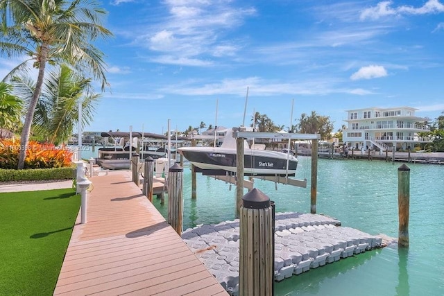 dock area featuring boat lift and a water view