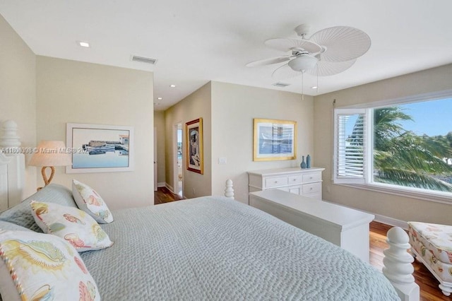 bedroom with wood finished floors, ceiling fan, recessed lighting, and baseboards