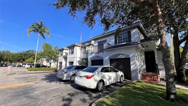 781 SW 148th Ave Unit 1513, Sunrise, FL 33325 - view of property featuring a balcony, stucco siding, uncovered parking, and a residential view