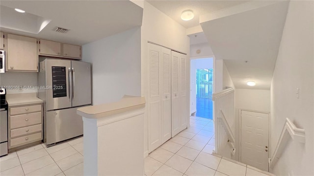 781 SW 148th Ave Unit 1513, Sunrise, FL 33325 - kitchen with appliances with stainless steel finishes, light tile patterned floors, light countertops, and a peninsula