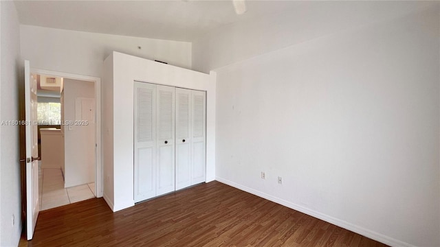 781 SW 148th Ave Unit 1513, Sunrise, FL 33325 - unfurnished bedroom featuring dark wood-style flooring, a closet, baseboards, and lofted ceiling