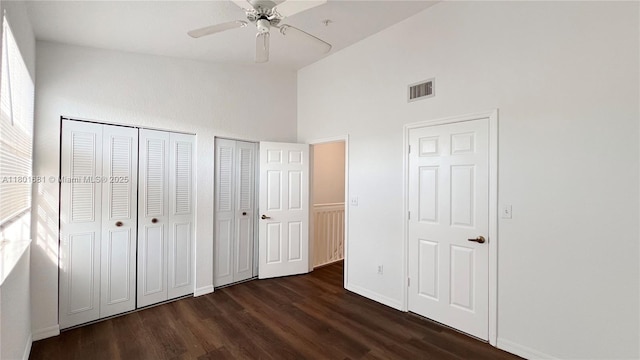 781 SW 148th Ave Unit 1513, Sunrise, FL 33325 - unfurnished bedroom with multiple closets, dark wood finished floors, high vaulted ceiling, baseboards, and a ceiling fan