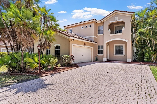 5832 NW 120th Ave, Coral Springs, FL 33076 - view of front facade featuring stucco siding, decorative driveway, an attached garage, a tile roof, and a balcony