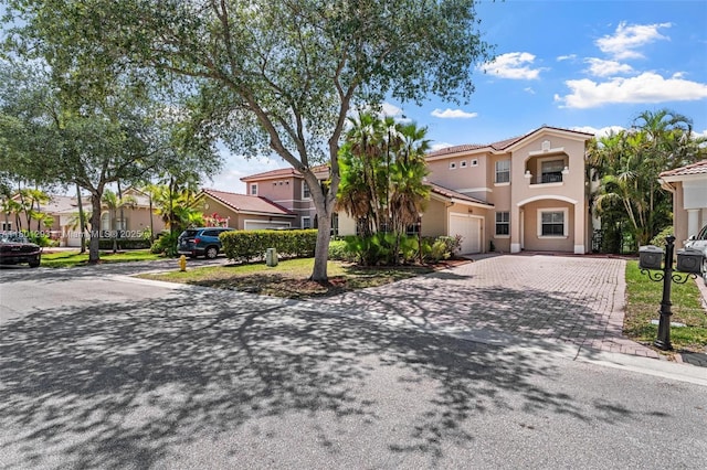 5832 NW 120th Ave, Coral Springs, FL 33076 - view of front of house featuring decorative driveway, stucco siding, a tiled roof, an attached garage, and a residential view
