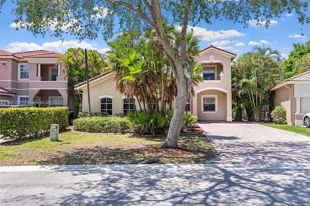5832 NW 120th Ave, Coral Springs, FL 33076 - mediterranean / spanish-style home with driveway, stucco siding, and a tiled roof