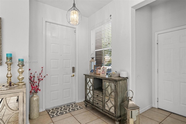 5832 NW 120th Ave, Coral Springs, FL 33076 - entrance foyer featuring light tile patterned floors, a chandelier, and baseboards