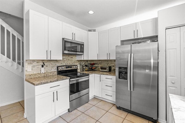 5832 NW 120th Ave, Coral Springs, FL 33076 - kitchen featuring appliances with stainless steel finishes, decorative backsplash, light tile patterned floors, light stone countertops, and recessed lighting