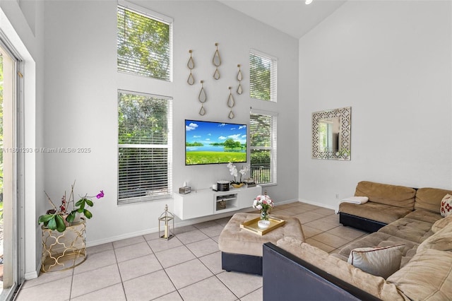 5832 NW 120th Ave, Coral Springs, FL 33076 - living area featuring high vaulted ceiling, light tile patterned floors, and baseboards