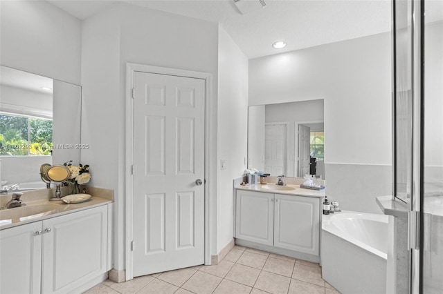 5832 NW 120th Ave, Coral Springs, FL 33076 - full bath with two vanities, a bath, and tile patterned flooring