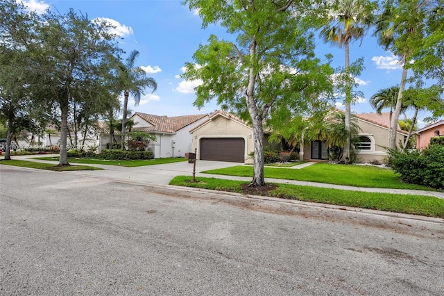 782 Lake Blvd, Weston, FL 33326 - view of front facade with a tiled roof, driveway, stucco siding, and an attached garage