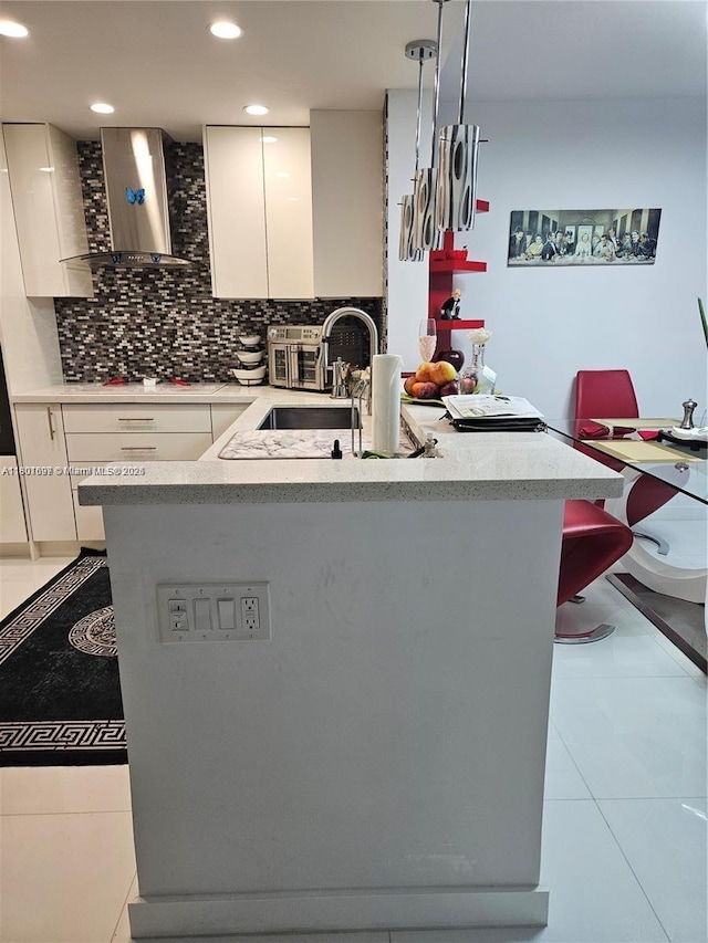 619 NE 14th Ave Unit 106, Hallandale Beach, FL 33009 - kitchen with wall chimney exhaust hood, white cabinetry, backsplash, a sink, and recessed lighting