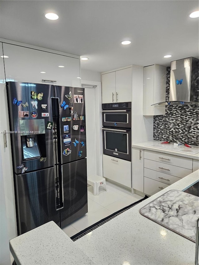 619 NE 14th Ave Unit 106, Hallandale Beach, FL 33009 - kitchen with refrigerator with ice dispenser, wall chimney range hood, white electric stovetop, white cabinets, and multiple ovens