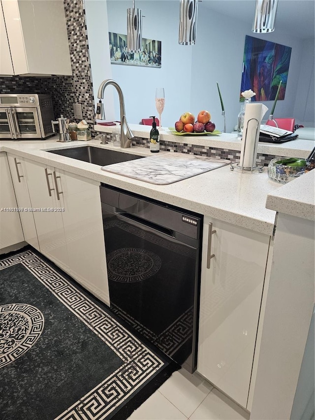 619 NE 14th Ave Unit 106, Hallandale Beach, FL 33009 - kitchen with white cabinetry, a sink, light stone counters, wall oven, and decorative backsplash