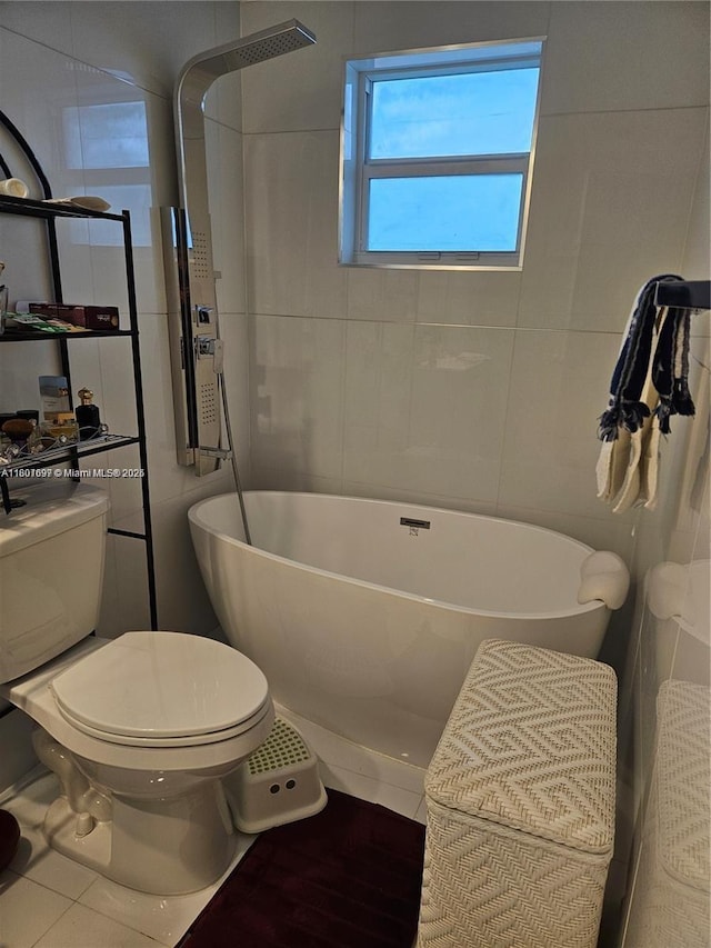 619 NE 14th Ave Unit 106, Hallandale Beach, FL 33009 - bathroom with toilet, a soaking tub, tile walls, and tile patterned floors