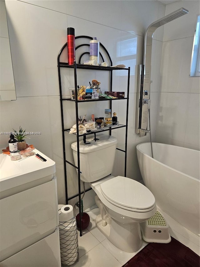 619 NE 14th Ave Unit 106, Hallandale Beach, FL 33009 - bathroom featuring toilet, a freestanding tub, a shower, tile patterned floors, and vanity