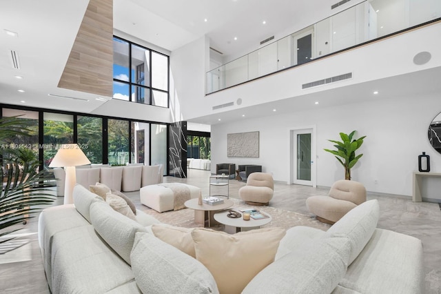 521 Holiday Dr, Hallandale Beach, FL 33009 - living area with a high ceiling, recessed lighting, light marble finish floors, and baseboards