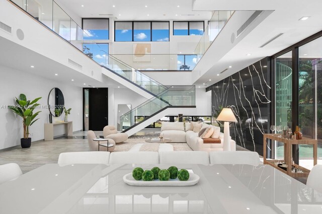 521 Holiday Dr, Hallandale Beach, FL 33009 - lobby featuring a wall of windows, a towering ceiling, and stairs