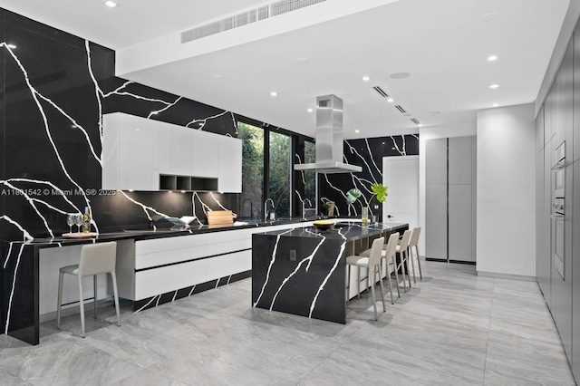 521 Holiday Dr, Hallandale Beach, FL 33009 - kitchen with island range hood, modern cabinets, recessed lighting, a kitchen island, and decorative backsplash