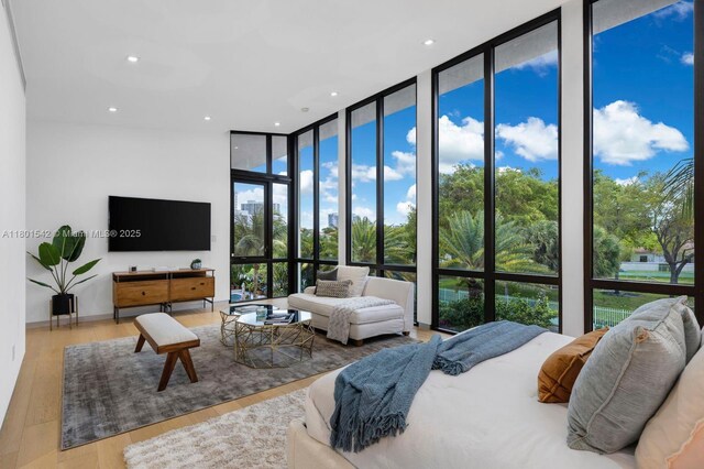 521 Holiday Dr, Hallandale Beach, FL 33009 - bedroom with expansive windows, wood finished floors, and recessed lighting