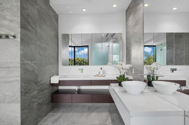 521 Holiday Dr, Hallandale Beach, FL 33009 - bathroom featuring double vanity, tile walls, and recessed lighting