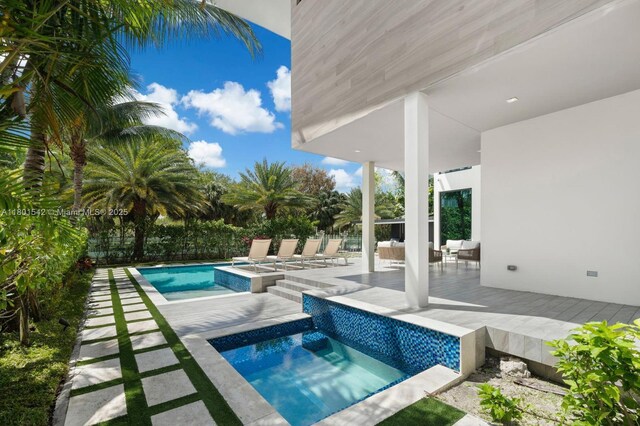 521 Holiday Dr, Hallandale Beach, FL 33009 - swimming pool with a jacuzzi, a deck, and outdoor lounge area