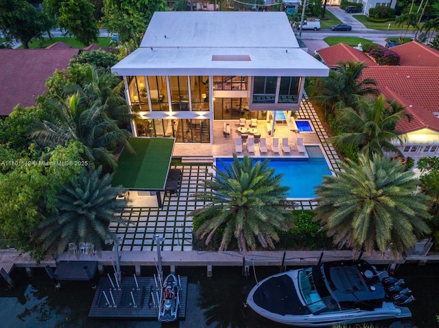 521 Holiday Dr, Hallandale Beach, FL 33009 - back of property featuring an outdoor pool and a patio