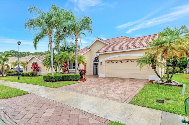view of front of home featuring stucco siding, decorative driveway, an attached garage, and a front yard