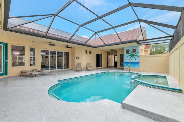 view of swimming pool featuring a ceiling fan, a patio, a lanai, and a pool with connected hot tub