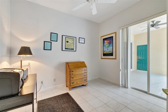 sitting room with ceiling fan, light tile patterned floors, and baseboards