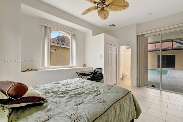 bedroom featuring light tile patterned flooring, access to outside, ensuite bathroom, and ceiling fan
