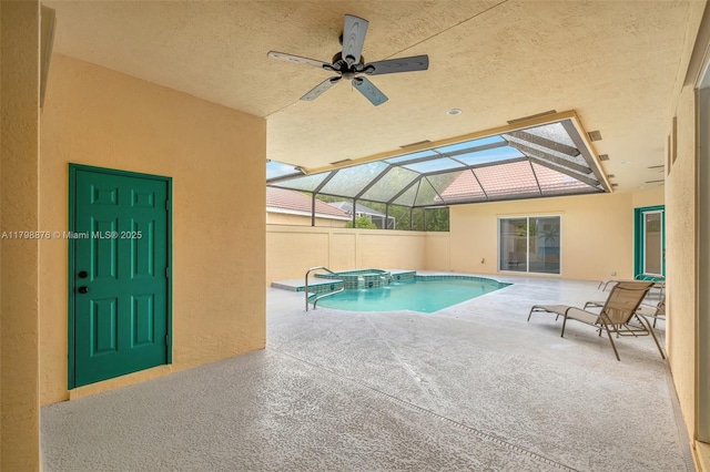 view of pool with a pool with connected hot tub, a patio, ceiling fan, and a lanai