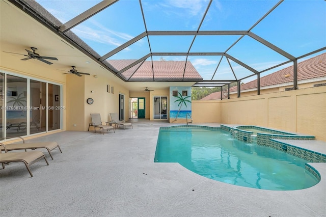 view of pool with a ceiling fan, a patio, a lanai, and a pool with connected hot tub
