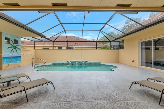 view of swimming pool with a patio area, glass enclosure, and a pool with connected hot tub