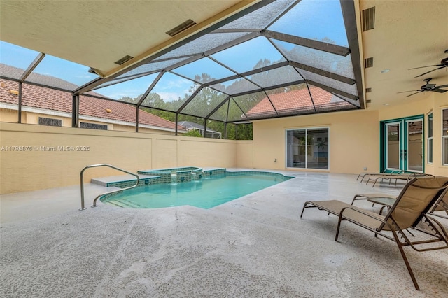 view of pool featuring a pool with connected hot tub, a patio area, a ceiling fan, and a lanai