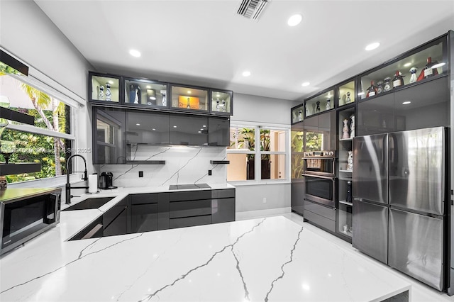 1496 Breakwater Ter, Hollywood, FL 33019 - kitchen with a sink, stainless steel appliances, recessed lighting, modern cabinets, and light stone counters