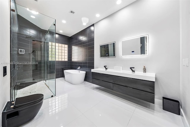 1496 Breakwater Ter, Hollywood, FL 33019 - bathroom with a shower stall, a freestanding bath, double vanity, tile patterned floors, and recessed lighting