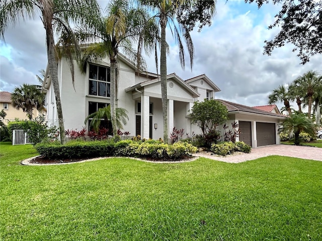 3968 Nighthawk Dr, Weston, FL 33331 - view of front of home featuring stucco siding, a garage, a front yard, and driveway