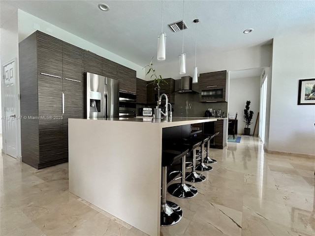 3968 Nighthawk Dr, Weston, FL 33331 - kitchen with stainless steel refrigerator with ice dispenser, modern cabinets, a kitchen bar, light marble finish floors, and recessed lighting